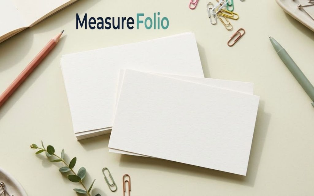 Several blank index cards stacked and fanned on a pastel desk with colorful study accessories.